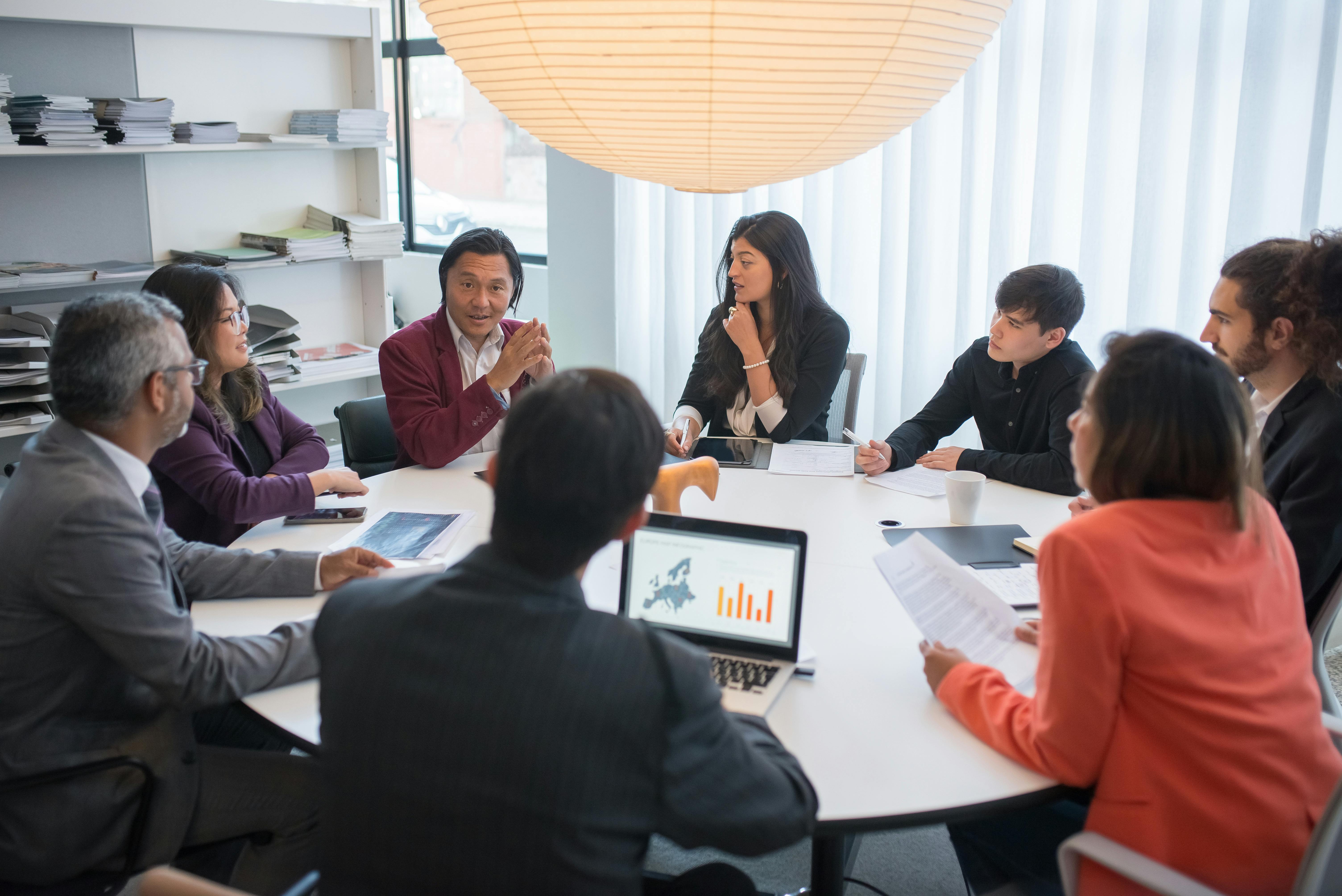 Professional team meeting discussing financial strategies in modern office - Credence Global consultation services with certified tax experts