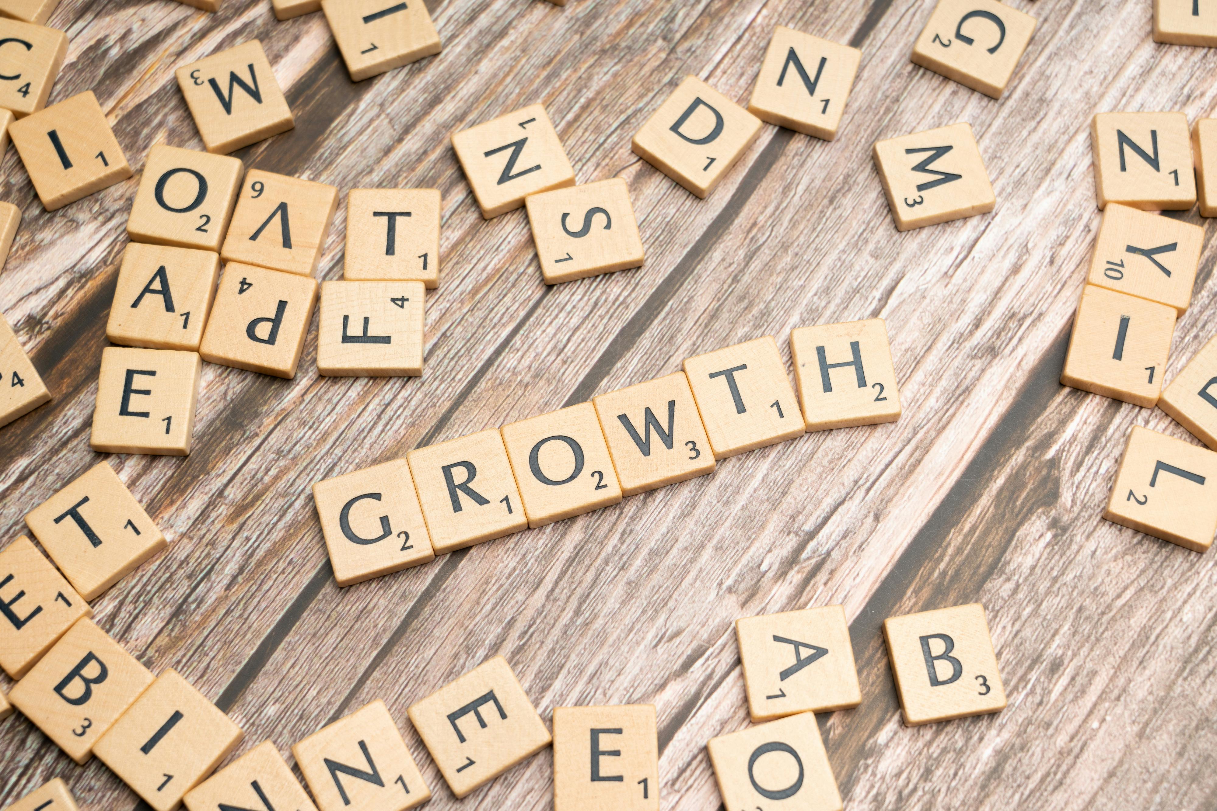 Scrabble tiles spelling GROWTH representing business development and progress at Credence Global