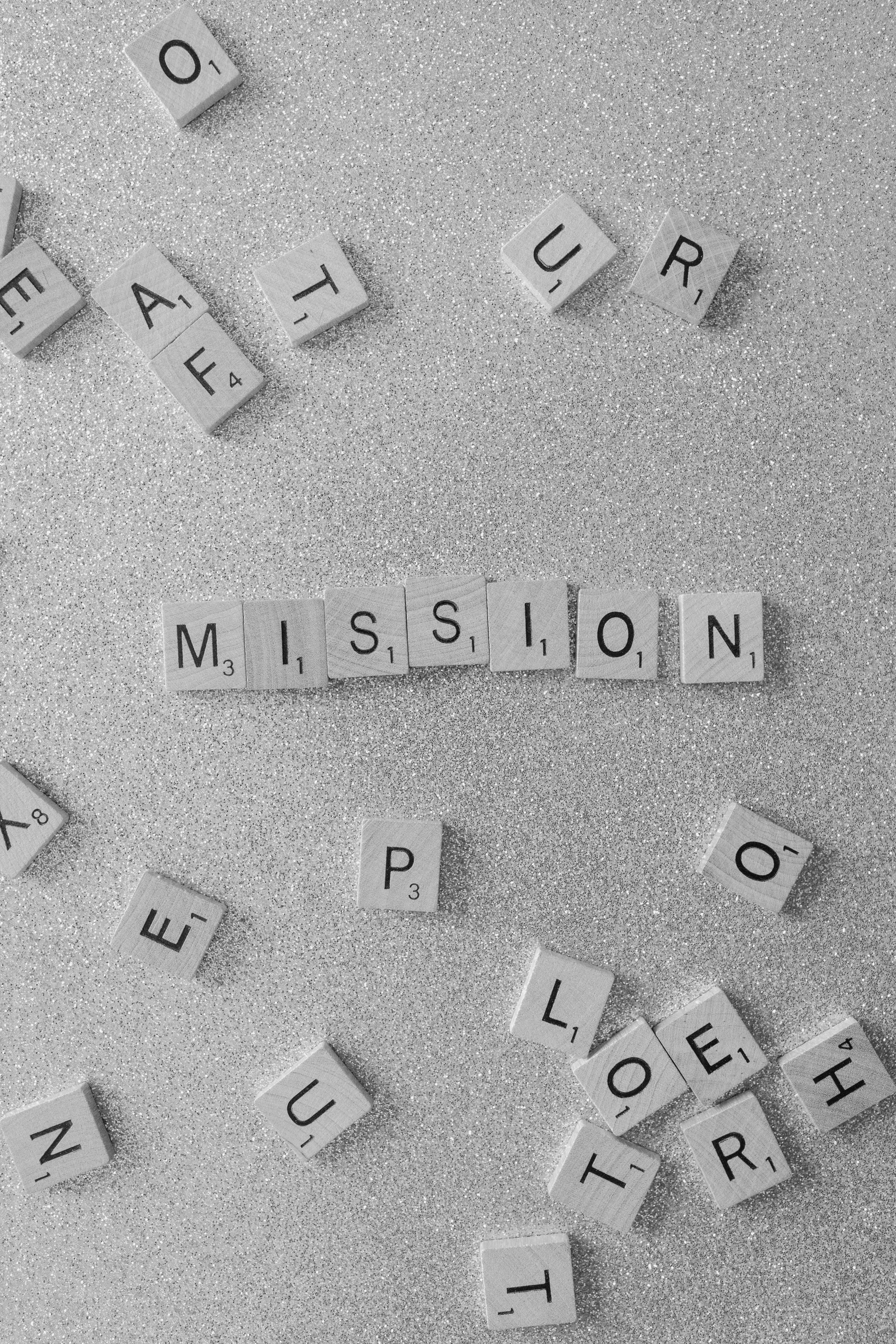 Scrabble tiles spelling out MISSION representing Credence Global's core purpose and values