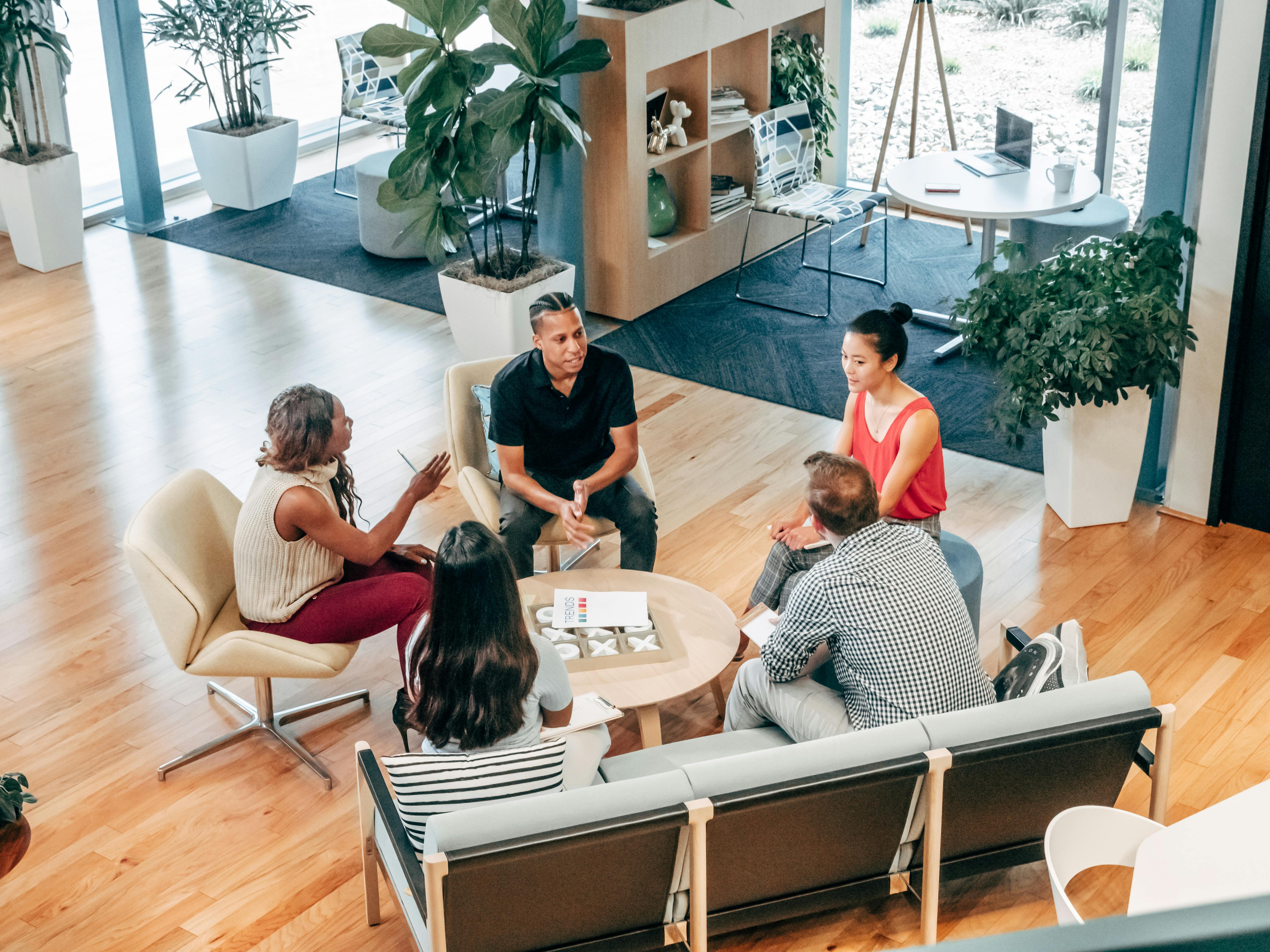 Diverse team collaborating in modern office environment showcasing teamwork and innovation at Credence Global